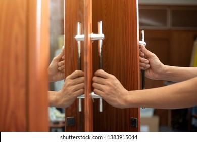 People Are Holding The Door Handle To Open The Closet.wardrobe Door Handle.