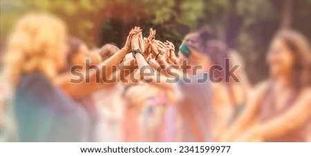 People holding hands at a festival ceremony.