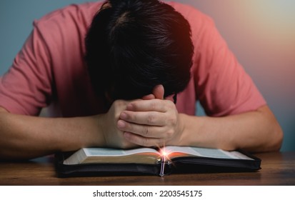 People Holding Hands Head Bow Down  Pray To God In The Middle Book Holy Bible Book With Cross Necklace Front Of The Holy Bible.