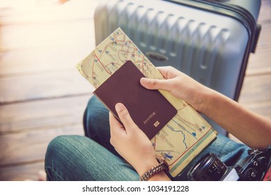 People holding passports, map for travel with luggage for the trip  - Shutterstock ID 1034191228