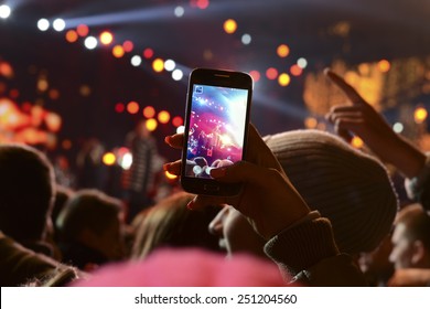 People Holding Their Smart Phones And Photographing Concert