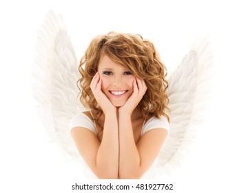 people, holidays, christmas and religious concept - happy young woman or teen girl with angel wings over white background