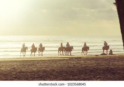 People horseback riding on shore in Costa Rica, Central America - Powered by Shutterstock