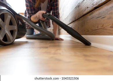 People, housework and housekeeping concept - happy woman with vacuum cleaner at home. Spring cleaning - Shutterstock ID 1043321506