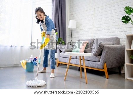 People, housework and housekeeping concept - Happy Asian woman or housewife with mop cleaning floor and dancing at home. Imagine de stoc © 