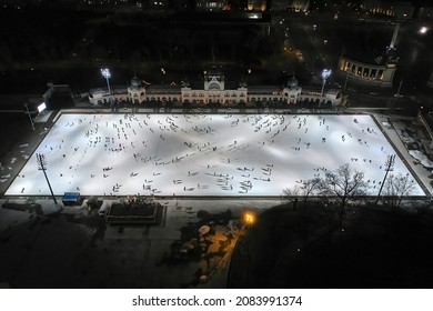 People Ice Skating On A Large Ice Rink In Budapest, Aerial Top Down View From High Angle