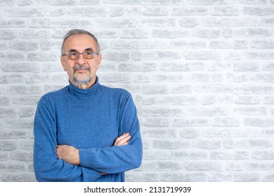 People Individual Lifestyle Concept. Portrait Of Virile Serious Minded Self-assured Pensive Granddad With Crossed Hands Blue Sweater Isolated On Gray Brick Wall Background Copy-space.