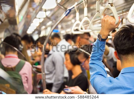 People inside the crowded metro train. Singapore