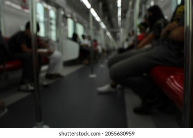 People inside the train commute to work during rush hour to save time on car commutes. Blurred image.