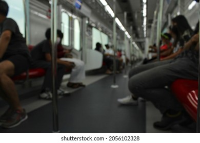 People inside the train commute to work during rush hour to save time on car commutes. Blurred image.