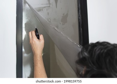 People Installing Sticker Film To Mirror Window House Interior Decoration