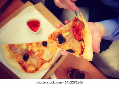 People, Italian Cuisine Concept. Young Bearded Man Eating Hot Fresh Pizza Adding Tomato Sauce. Delicious Fast Food Meal.