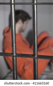 People In Jail - Caucasian Man In Prison Cell - Department Of Justice Orange Jump Suit