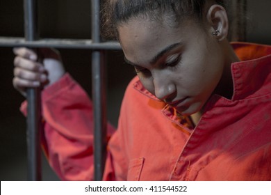 People In Jail - Young Woman Looking Sad Holding Onto The Prison Bars