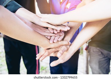 People join hand together during their work - human commitment concept - Shutterstock ID 1332799655