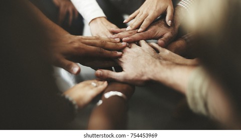 People with joined hands as a team - Shutterstock ID 754453969