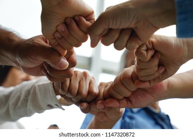 People joining hands and stack hands together for showing teamwork ,unity and collaboration. Business teamwork concept.