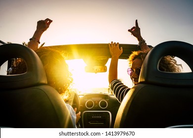 People joy and happy driving and traveling for summer holiday vacation and outdoor leisure activity with convertivle car laughing and dancing like crazy - sunlight in the glass and travel concept - Powered by Shutterstock