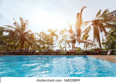 people jumping to the swimming pool, beach holidays, friends having fun together - Powered by Shutterstock