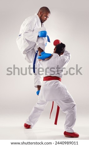 People, karate and attack with training in studio on white background to fight or practice for competition. Mma, sport and kick or respect with fitness, commitment and confidence as fighter