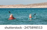 People kayaking in the baja, at TECOLOTE Beach with mountains in the background. La Paz Baja California Sur. MEXICO. Baja style Holidays