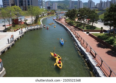 People kayaking in the (canal way) canal - Cheongna International City, Korea - Shutterstock ID 2105521568