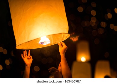 People is launching sky lantern to the sky