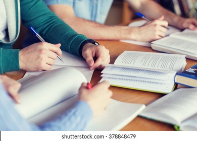 people, learning, education and school concept - close up of students hands with books or textbooks writing to notebooks - Shutterstock ID 378848479
