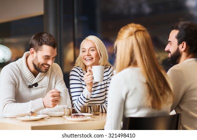 people, leisure and communication concept - happy friends meeting and drinking tea or coffee at cafe - Powered by Shutterstock