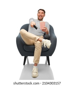 People And Leisure Concept - Happy Laughing Man With Tv Remote Control And Popcorn Sitting In Chair Over White Background