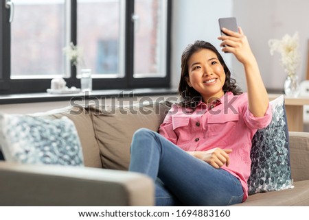 Similar – Young asian woman taking photo with her smartphone