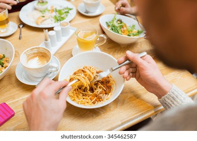 People, Leisure And Food Concept - Close Up Man Eating Pasta For Dinner At Restaurant Or Home