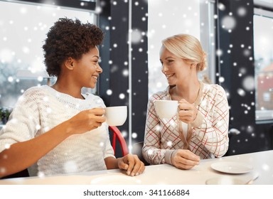 People, Leisure, Friendship And Communication Concept - Happy Young Women Meeting And Drinking Tea Or Coffee At Cafe Over Snow Effect