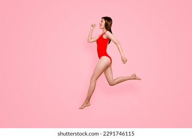 People life energy concept. Full-size portrait of fit sporty girl jumping over in the air isolated on yellow background with copy space for text