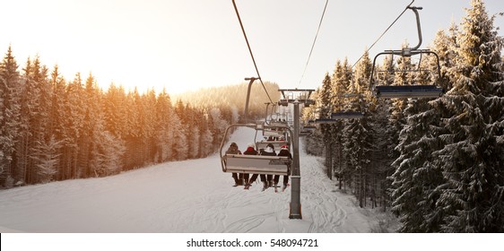 People are lifting on ski-lift in the mountains