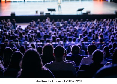 People listen to the speaker on the forum in the conference room. Blue lighting - Shutterstock ID 1718593228