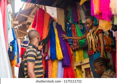 People In A Local African Market Shop Where They Sell Clothing Materials