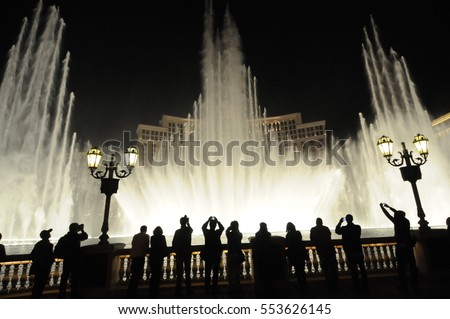 People look at night view of the fountain of Bellagio, Las Vegas, Nevada, USA