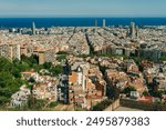 people look at the view of the city from the Bunkers del Carmel on a clear sky in Barcelona, Spain - may 2 2024. High quality photo