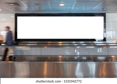 People Looking Blank Billboard In The City Building, Shot In Subway Station. Useful For Your Advertising. Selective Focus.