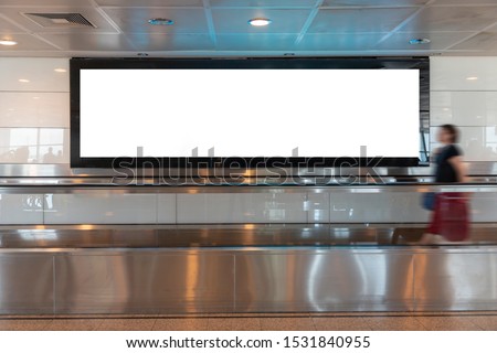 People looking Blank billboard in the city building, shot in subway station. Useful for your advertising. Selective Focus.