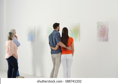 People Looking At Picture In Art Gallery