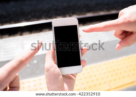 People looking at a smart phone