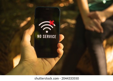 People lost in the woods, searching for help, hand holding mobile phone without cellular coverage, searching for the service or signal concept - Shutterstock ID 2044333550