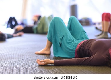 People Lying Down In A Group Yoga Practice, Resting.