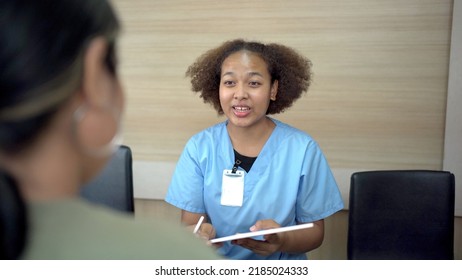 People making an appointment with medical staffs at reception desk in hospital. Medical staff and nurse - receptionist talking to patient in front of the reception counter in hospital. - Shutterstock ID 2185024333