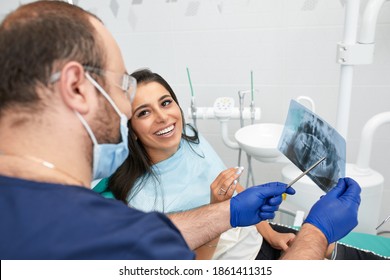 people, medicine, stomatology and health care concept - happy male dentist showing work plan to woman patient at dental clinic office - Powered by Shutterstock