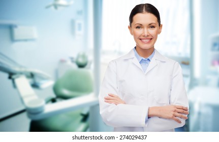 people, medicine, stomatology and healthcare concept - happy young female dentist with tools over medical office background - Powered by Shutterstock