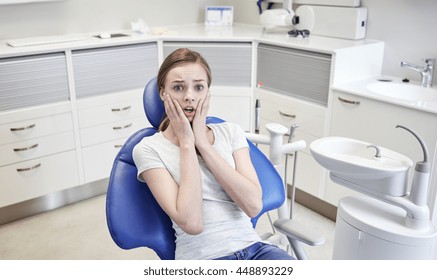 people, medicine, stomatology and phobia concept - scared and terrified patient girl at dental clinic office - Powered by Shutterstock