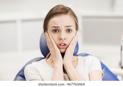 people, medicine, stomatology and phobia concept - scared and terrified patient girl at dental clinic office - Powered by Shutterstock